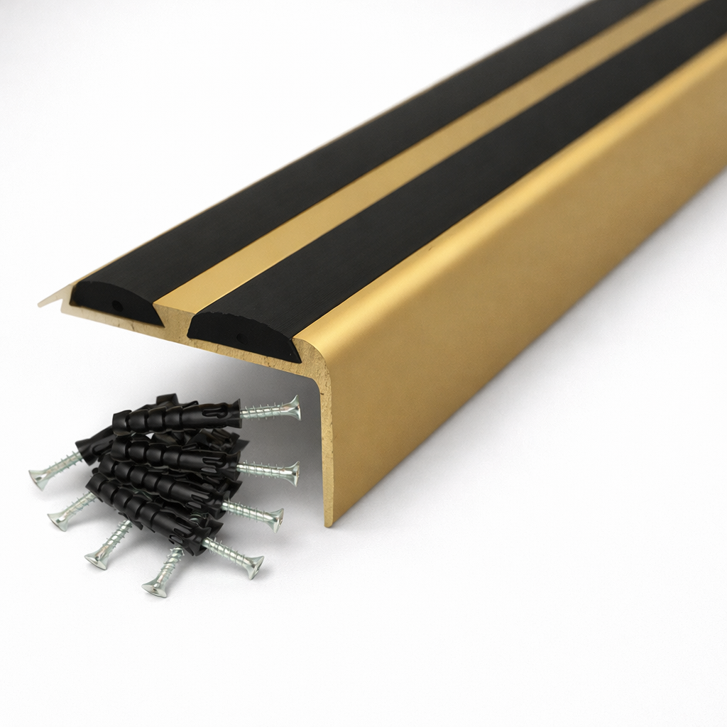Gold Anodised aluminium stair nosing with rubber inserts installed on staircase step