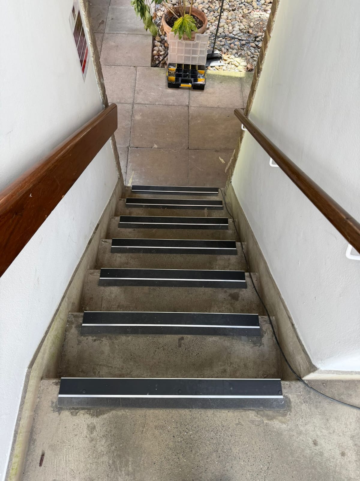 Black aluminium anti-slip stair nosing fitted to outdoor concrete steps