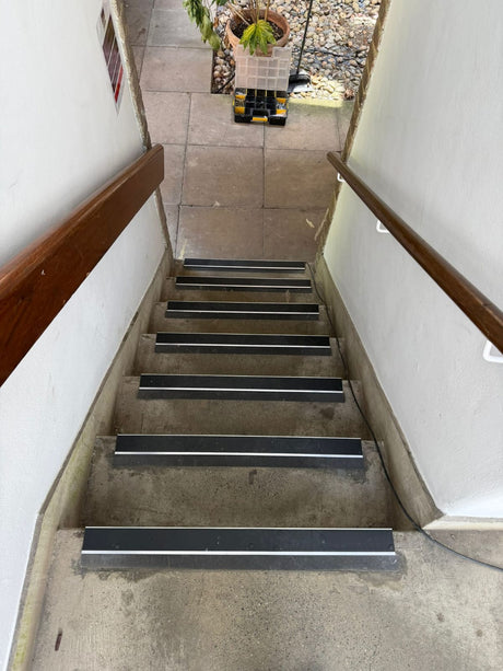 Black aluminium anti-slip stair nosing fitted to outdoor concrete steps