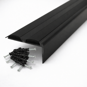 Black Anodised aluminium stair nosing with rubber inserts installed on staircase step