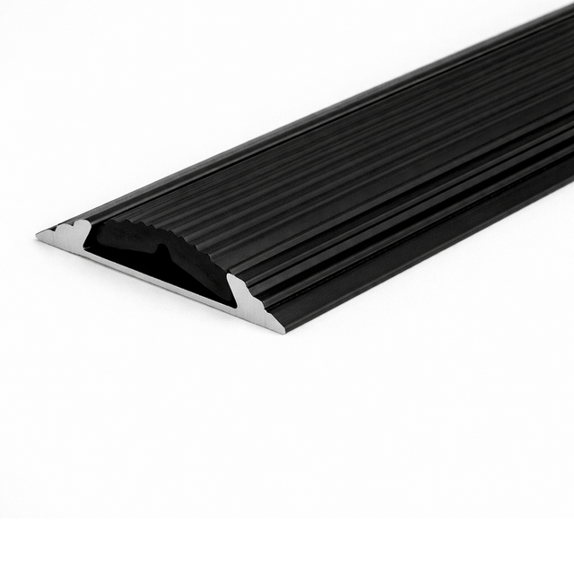 Black A10 anodised aluminium flat non-slip threshold strip installed between two floor surfaces for added safety.