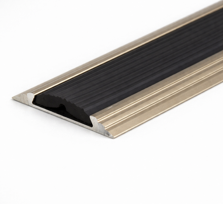 Champagne A10 anodised aluminium flat non-slip threshold strip installed between two floor surfaces for added safety.