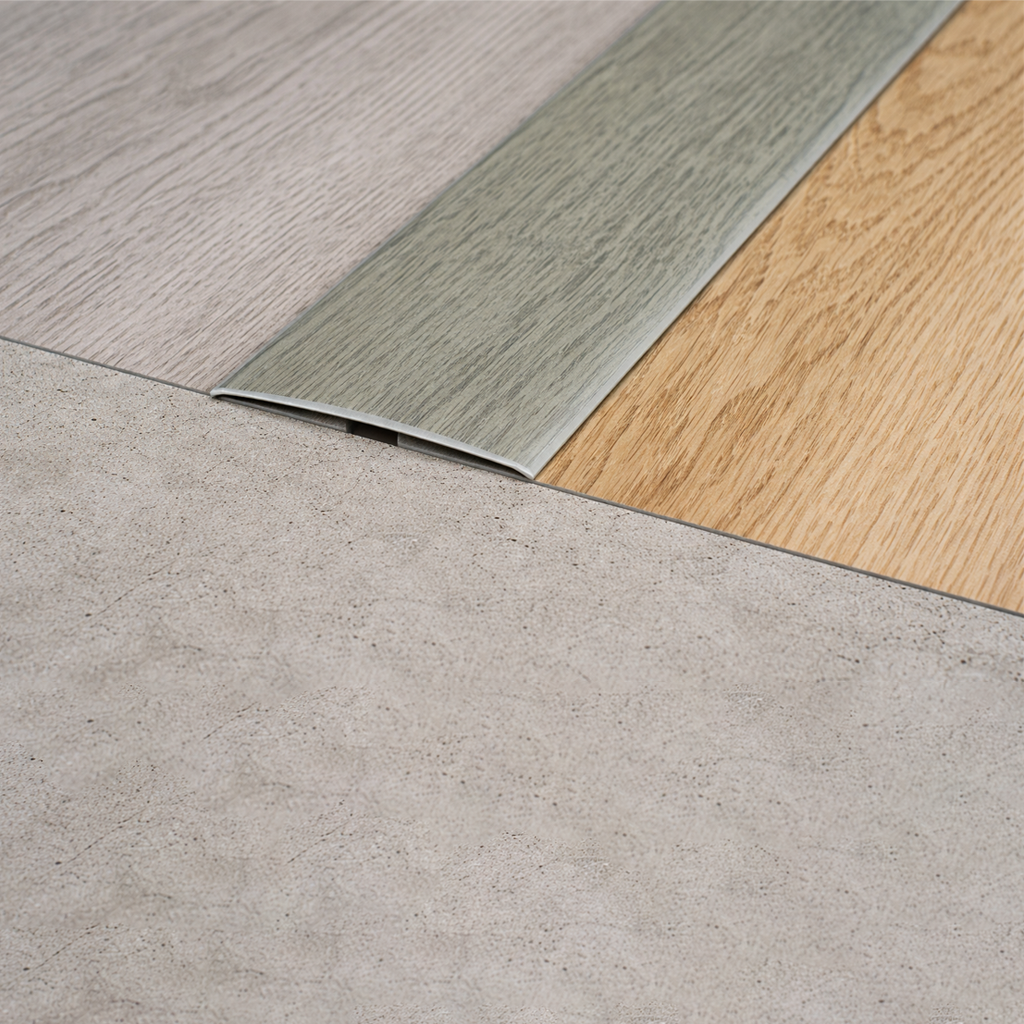 Aluminium wood effect 35mm flat self adhesive threshold strip installed on doorway floor