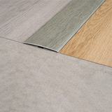 Aluminium wood effect 35mm flat self adhesive threshold strip installed on doorway floor