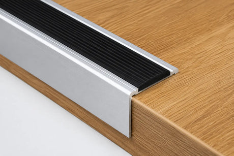 Aluminium stair nosing with anti-slip rubber insert installed on wooden step